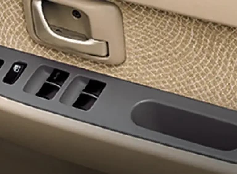 Detail panel pintu mobil dengan tombol power window dan door lock yang mudah dijangkau. Desain warna beige memberi kesan bersih dan nyaman. Material dibuat kuat untuk penggunaan harian serta memudahkan pengemudi mengatur kaca jendela dengan cepat.