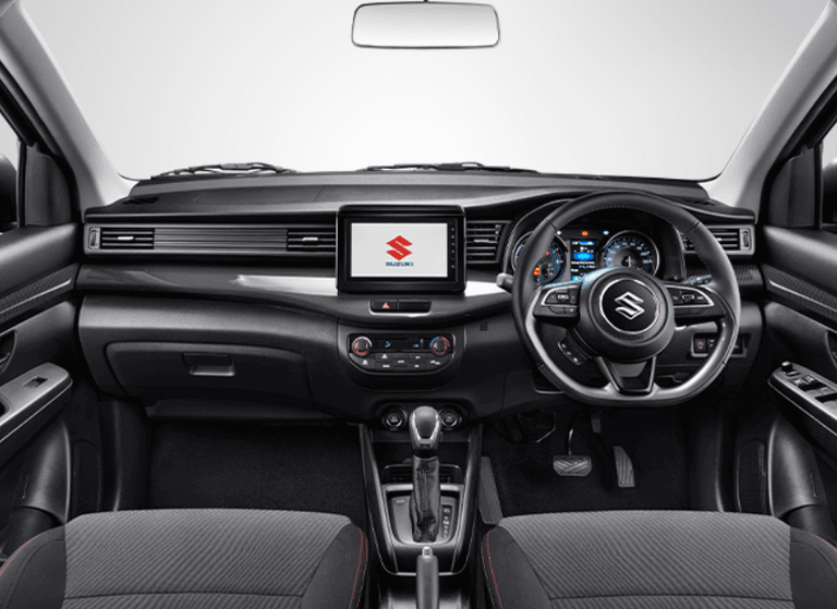 Interior All New Ertiga Cruise tampil elegan dengan kabin dominan hitam yang sporty. Dilengkapi aksen charcoal, panel instrumen berdesain modern, head unit 8 inci, ventilasi AC belakang, serta ruang kabin lega yang nyaman untuk 7 penumpang.